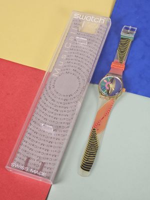 a watch that is sitting on a colorful surface