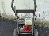 a small lawn mower that is sitting on the ground