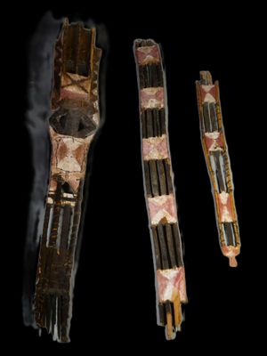 three pieces of wood with different patterns on them on a black background