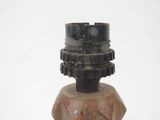a small wooden object with a metal object on top of it