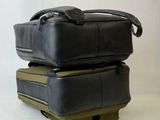 two pieces of luggage stacked on top of each other