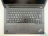 the laptop is open and has a red button on the keyboard