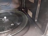 a close up of a stove with a pan inside of it