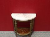 a small marble table in the corner of a room