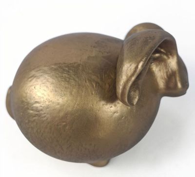 brass figurine of a pig on a white background