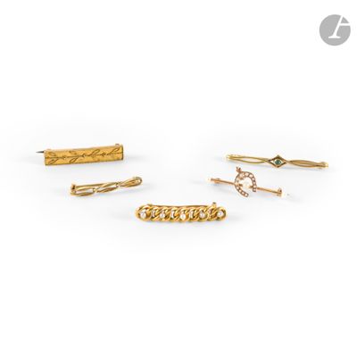 a set of five gold hair clips with diamonds on them