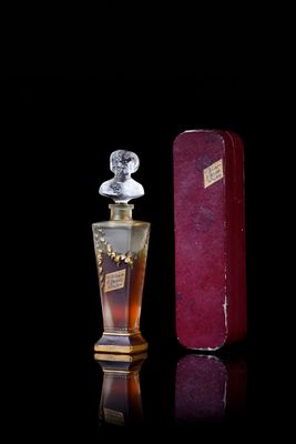 an image of a bottle of perfume on a black background