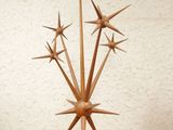 a wooden sculpture of a star on a shelf