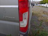 a close up of the tail light of a silver truck