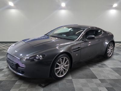 an image of a grey aston car in a showroom