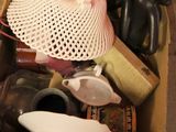 a cardboard box filled with assorted items on the floor