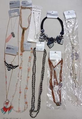 a lot of necklaces and bracelets that are on the table