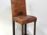 an old chair with a brown leather seat on a white background
