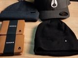 a wooden table with a hat, wallet, and other items on it