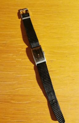a watch that is sitting on a wooden table
