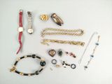 a lot of jewelry that is laying out on the table
