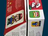 two boxes of nintendo wii games sitting on a table