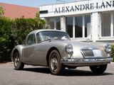a silver car that is parked in front of a building