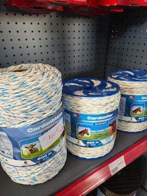 several rolls of rope are on a shelf in a store