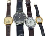 several different types of watches are lined up on a white surface