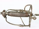 a silver sword with a metal handle on a clear surface