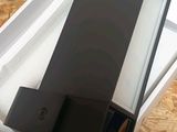 an open box with two speakers inside of it on a wooden floor