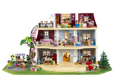 une maison de poupées avec plein de jouets par terre
