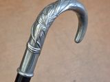 a close up of a silver and black umbrella with a handle