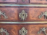 an image of a dresser with many drawers and handles