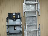 two ladders next to each other outside of a building