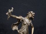 bronze statue of a woman holding a bouquet of flowers