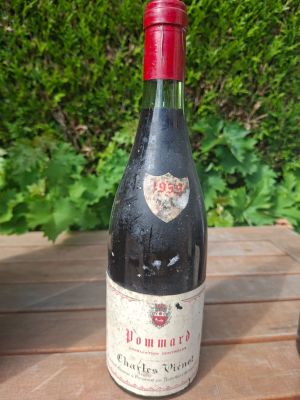 a bottle of wine sitting on a wooden table