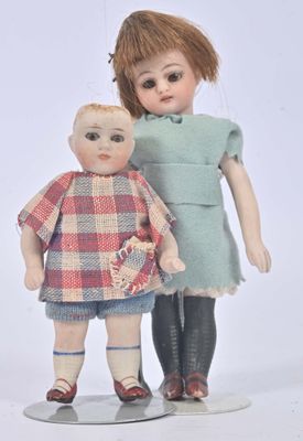 two dolls that are standing next to each other