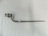 a metal pipe with a handle on a white sheet