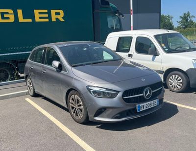 two cars parked in a parking lot next to a truck
