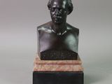 statue of a bust of a man sitting on a marble base
