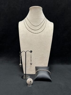 necklace, earring, ring, bracelet, and ring holder on a mannequin stand