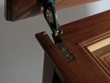 a close up of a door handle on a wooden door
