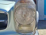 a silver car that is parked in front of a garage