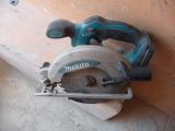 a circular saw sitting on top of a piece of wood