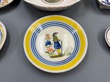 many plates with different designs on them on a table
