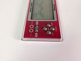 a red electronic device sitting on a white surface