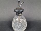 an old fashioned glass perfume bottle with a metal top