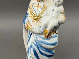 a figurine of a woman holding a child