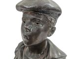 a statue of a boy with a beret on his head