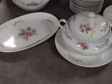 a lot of plates and bowls that are sitting on a table