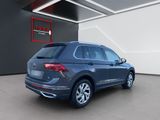 the rear end of a blue volkswagen suv parked in a garage