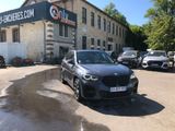 a black bmw suv parked in front of a building
