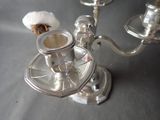a silver candelab with a cotton ball on top of it