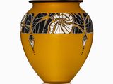 a yellow vase with a black and white design on it